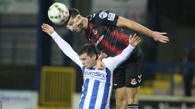 Crusaders defender Aidan Watson gets above Coleraine's Michael McCrudden at the Showgrounds