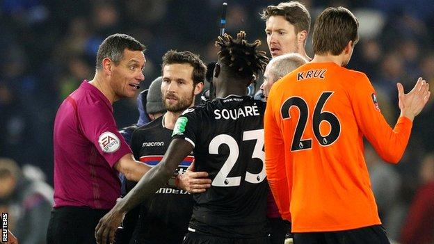 Andre Marriner explains his reasoning to the Palace players after Glenn Murray's winner