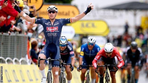 Tim Merlier celebrates as he wins the third stage of the Tour de France