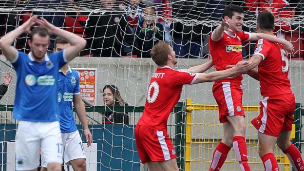 Cliftonville celebrate after Caoimhin Bonner headed them level at 2-2 against Premiership leaders Linfield at Solitude