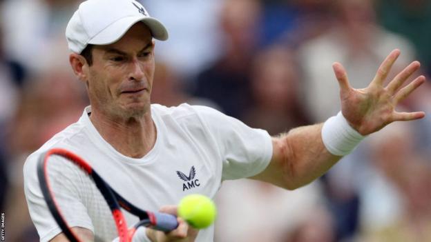 Andy Murray hits a return against Ryan Peniston in the Wimbledon first round