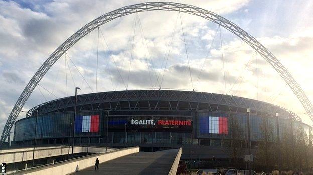 Wembley Stadium with the words 'Liberte, Egalite, Fraternite' written across it