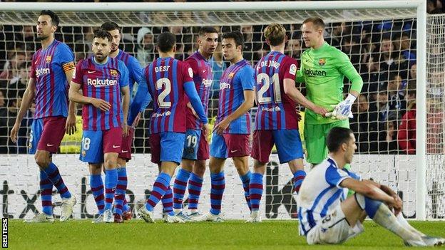 Barcelona's players react after beating Real Sociedad in La Liga
