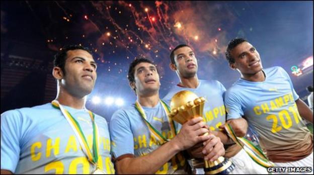 Egyptian players celebrate with the Nations Cup trophy in Luanda