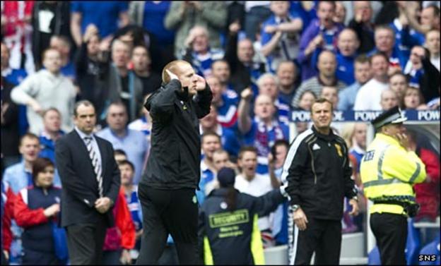 Celtic manager Neil Lennon signals to the Rangers fans