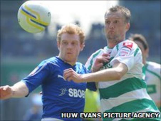 Cardiff City's Chris Burke battles with QPR's Clint Hill