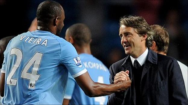 Manchester City boss Roberto Mancini (right) enjoys the win over Tottenham with midfielder Patrick Vieira