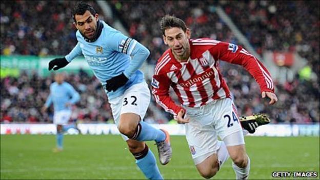 Manchester City's Carlos Tevez and Rory Delap of Stoke