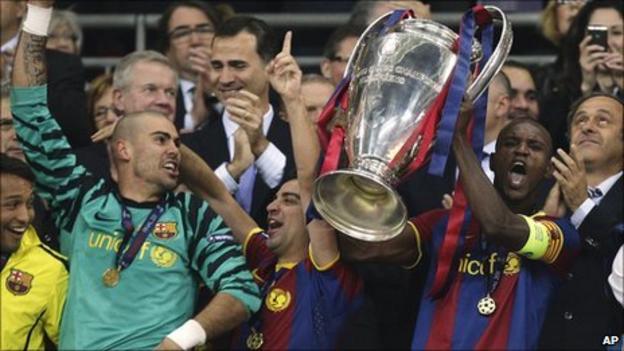 Eric Abidal lifts the cup as Barcelona win the Champions League