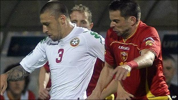 Bulgaria"s Ivan Bandalovski, left, challenges for the ball with Radomir Djalovic of Montenegro
