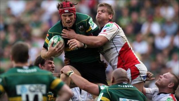 Northampton's Christian Day is tackled by Chris Henry of Ulster in last season's Heineken Cup quarter-finals