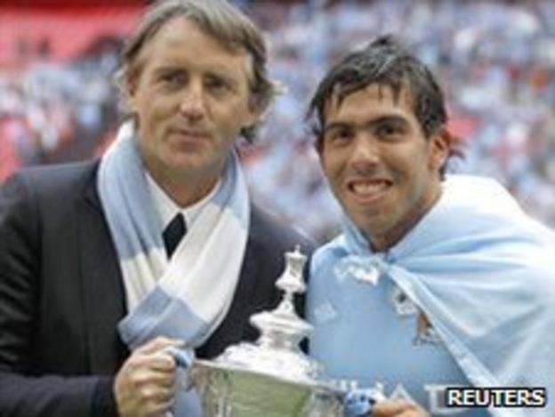 Manchester City boss Roberto Mancini and a striker Carlos Tevez celebrate winning last season's FA Cup