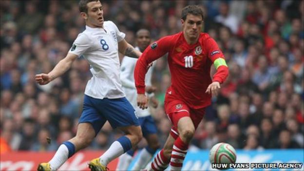 England's Jack Wilshere takes on Aaron Ramsey of Wales