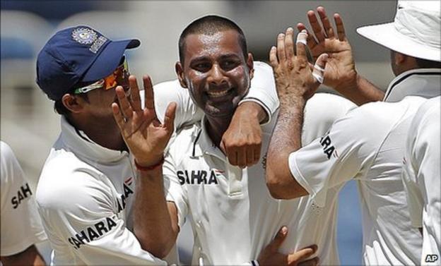 India's Praveen Kumar (centre) is congratulated by teammates Suresh Raina (left) and VVS Laxman
