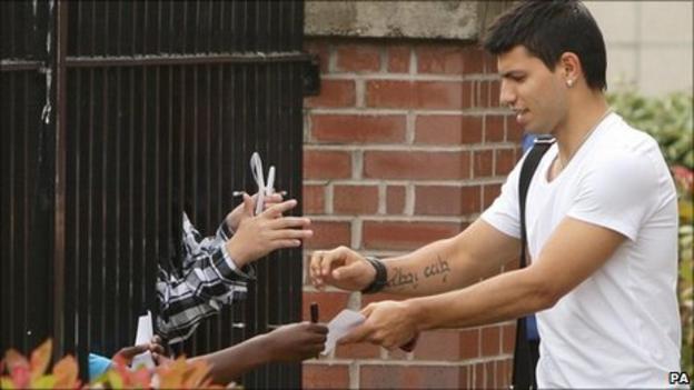 Sergio Aguero signs autographs after completing his medical