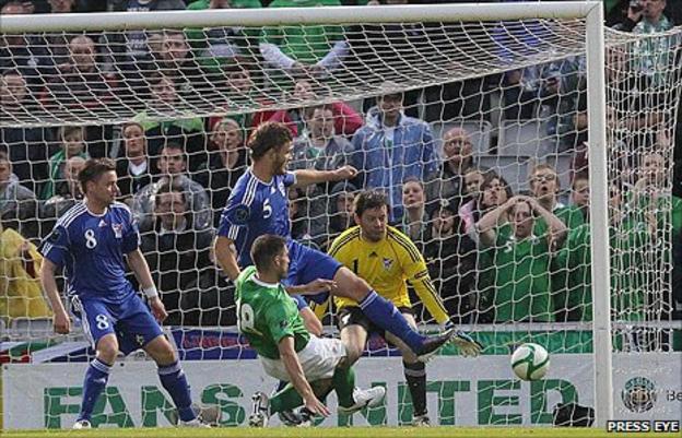 Aaron Hughes sends his shot in off the post to put Northern Ireland into the lead against the Faroe Islands