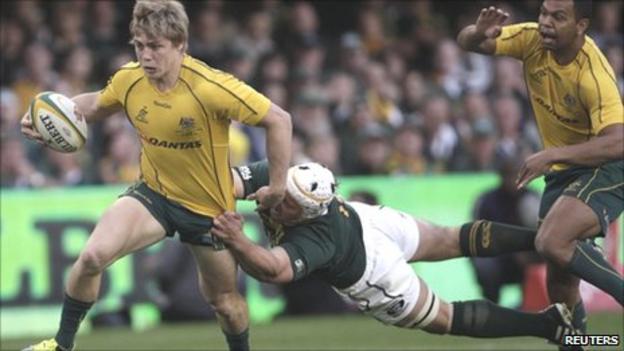 Australia wing James O'Connor tries to evade the tackle of South Africa's Heinrich Brussow