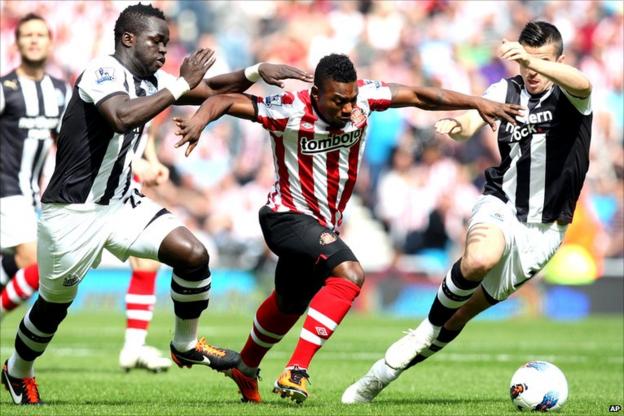 Stephane Sessegnon with two Newcastle United challengers