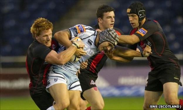 Cardiff's Tom James is tackled by three Edinburgh players