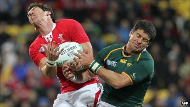 Wales full-back James Hook competes for the ball with South Africa fly-half Morne Steyn
