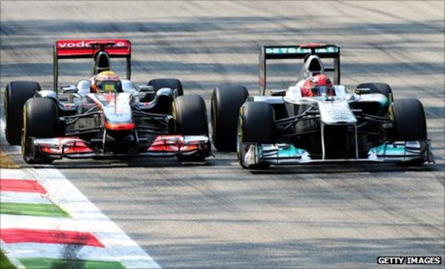 Michael Schumancher and Lewis Hamilton battle at Monza.