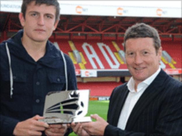 Harry Maguire (left) is given his Young Player of the Month award by Sheffield United boss Danny Wilson