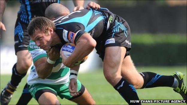 Ospreys fly-half Dan Biggar is tackled by Alberto Chillon of Treviso