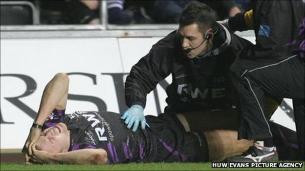 Tom Prydie receives medical attention after being injured playing for Ospreys against Glasgow