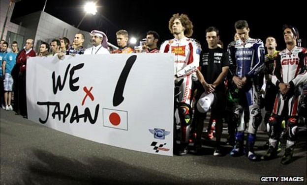 MotoGP riders stand for a minute of silence to honour the victims of the Japanese earthquake, 20 March 2011