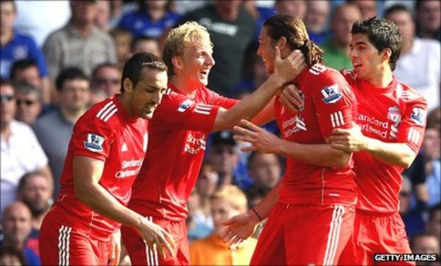 Jubilant Liverpool players congratulate Andy Carroll after the opening goal