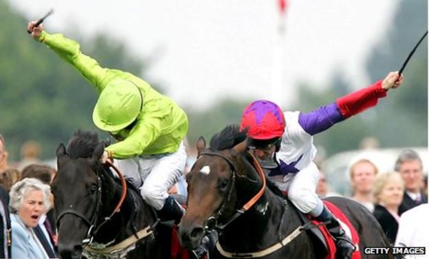 Jockeys use whips at Doncaster races