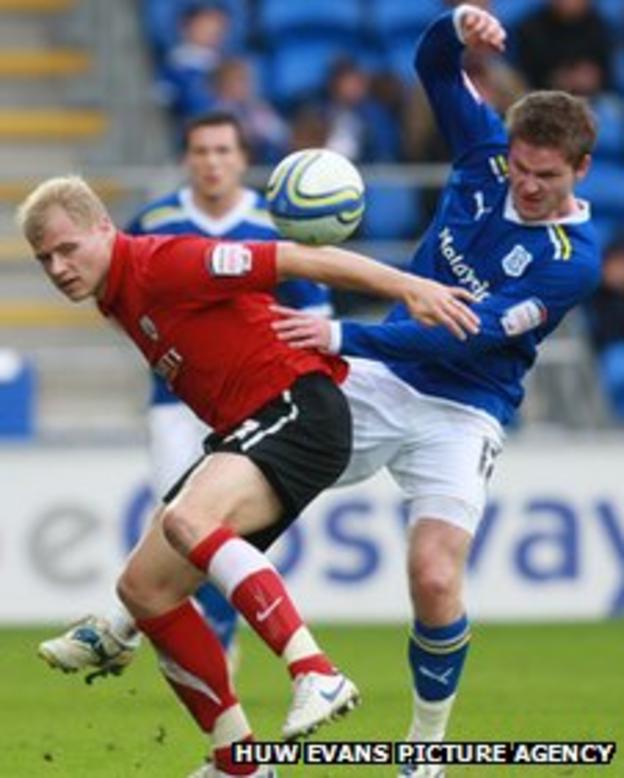Gunnarsson battles for the ball with Barnsley's Jay McEveley