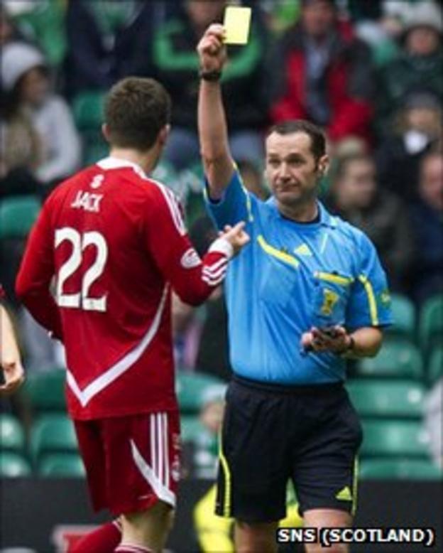 Aberdeen defender Ryan Jack is booked by referee Stevie O'Reilly