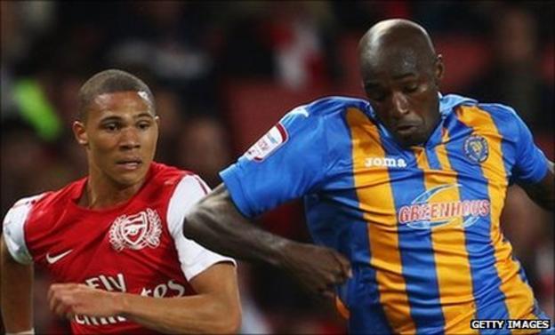Kieran Gibbs of Arsenal gives chase with Marvin Fof Shrewsbury Town