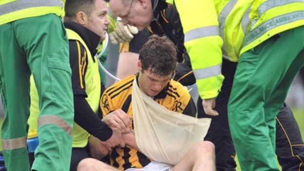 Paul Kernan is treated after disclocating a shoulder in the Casement Park game