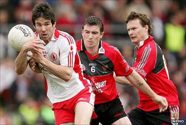 Tyrone's Ciaran Gourley in action against Liam Doyle and Daniel McCartan of Down
