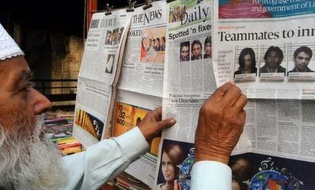 A man browsing newspapers in Pakistan