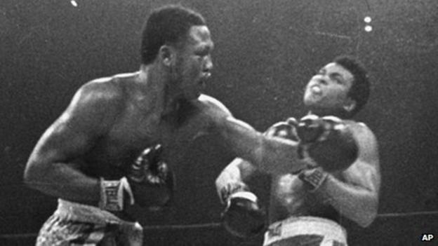 Joe Frazier hits Muhammad Ali with a left during their heavyweight title fight in 1971