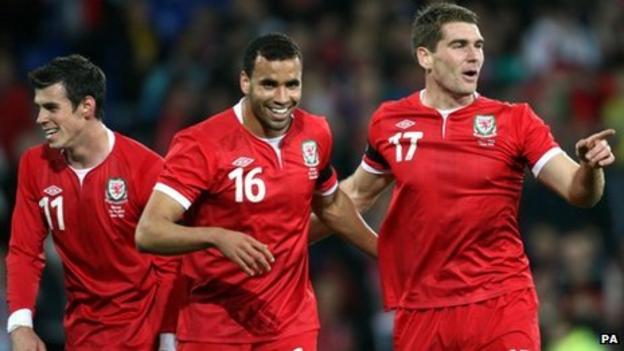 Sam Vokes (right) celebrates with Hal Robson-Kanu and Gareth Bale