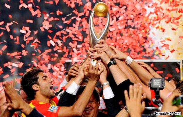 Esperance captain Oussama Darragi holds the African Champions League Trophy aloft