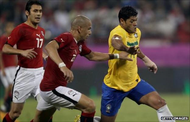 Ahmed Hassan (17) of Egypt. Givanildo Vieira (R) of Brazil vies for the ball with Wael Goma of Egypt (L)