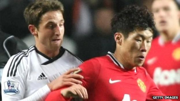 Joe Allen challenges Park Ji-Sung during Swansea City's 0-1 loss to Manchester United