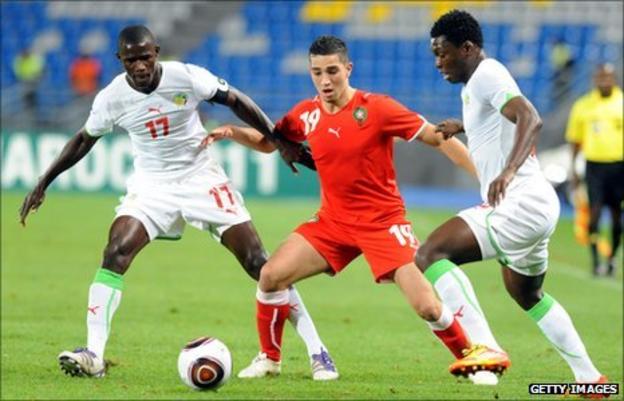 Senegalese duo Khassim Soumar and Younes Itri crowd out Lotfi Obilla of Morocco