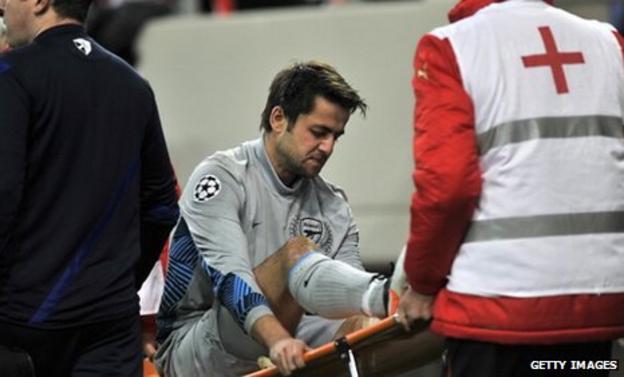 Lukasz Fabianski is stretchered off with a knee injury as Arsenal lose to Olympiakos