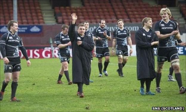 The Glasgow Warriors players take the applause of the fans