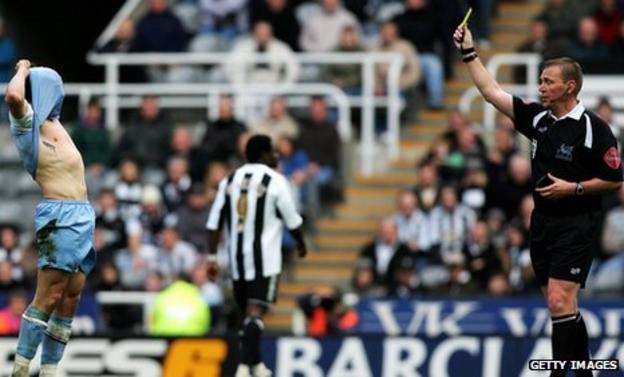 Graham Poll shows Joey Barton a yellow card