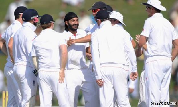 Monty Panesar (centre) is congratulated by his England team-mates