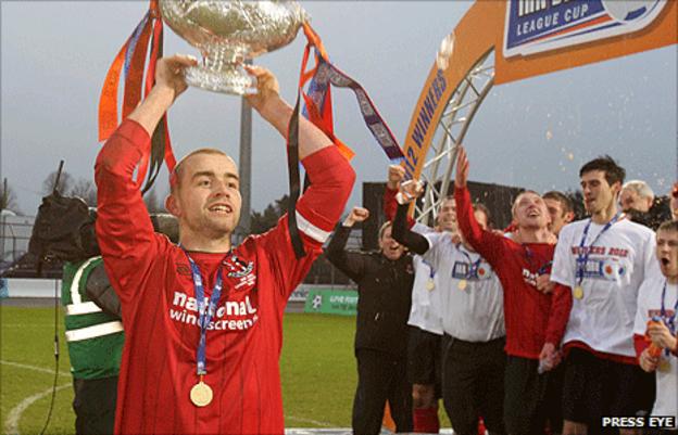 Crusaders captain Colin Coates lifts the League Cup after the wni over Coleraine