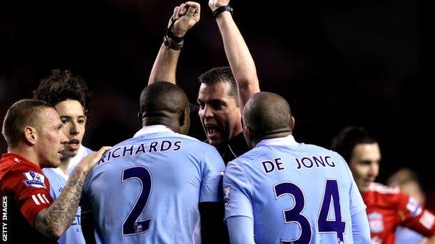 Micah Richards remonstrates with referee Phil Dowd at Anfield