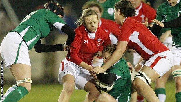 Laura Prosser of Wales tackles Amy Davis of Ireland before the game was abandoned